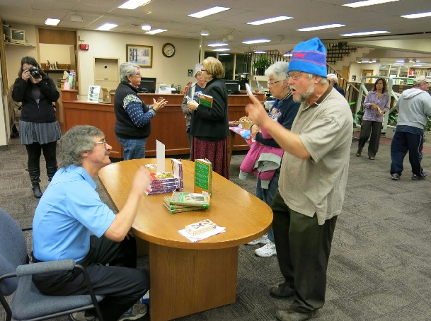 Author Ed Rice signs copies of his books and speaks to guests at the reception.